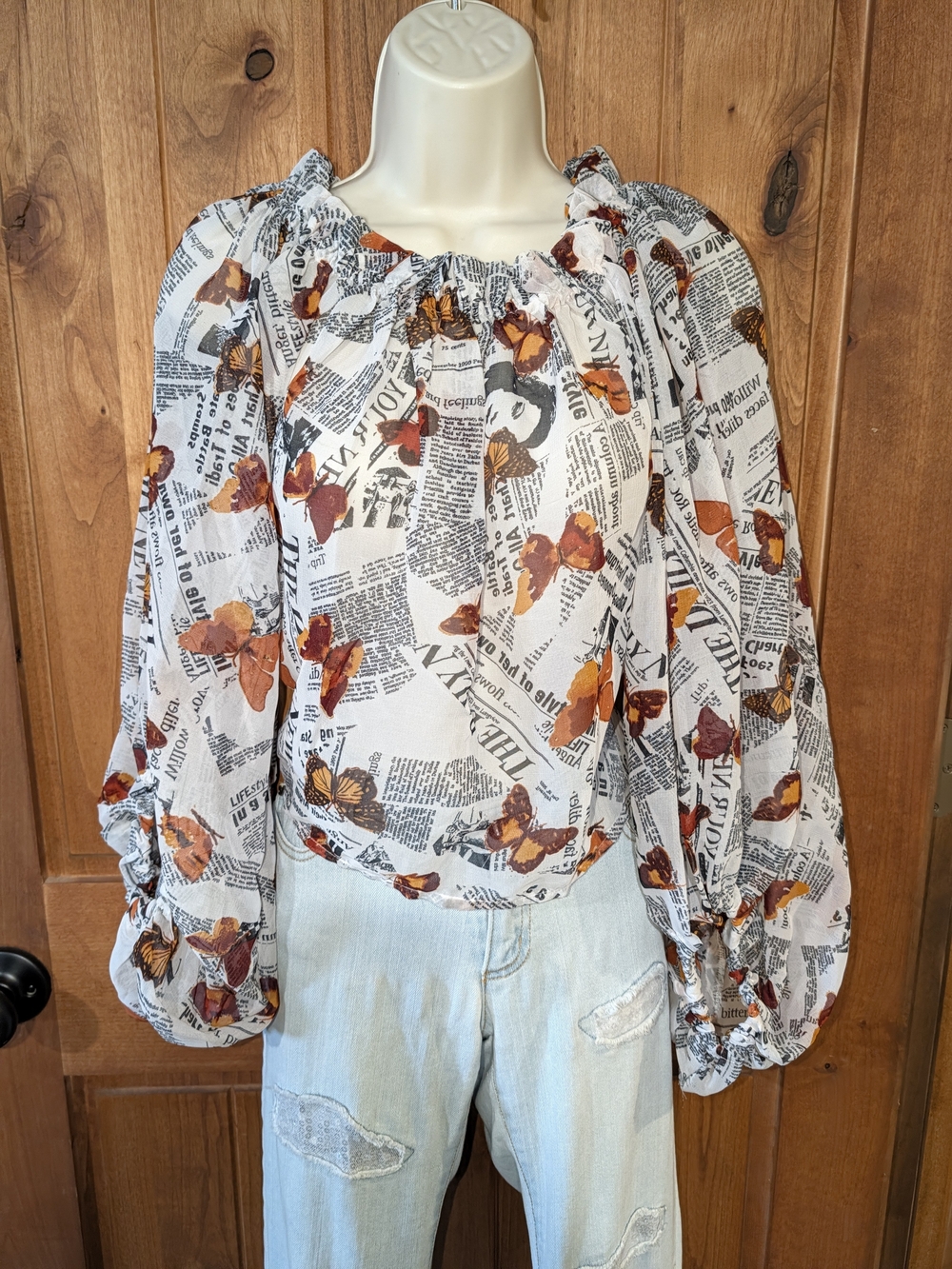 Live 4 Truth White Newspaper Print Blouse with Orange Butterfly Accents